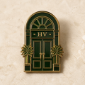 Boutique hotel enamel pin shaped like an arched doorway