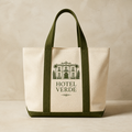 Boutique hotel canvas tote with forest green handles and hotel facade graphic