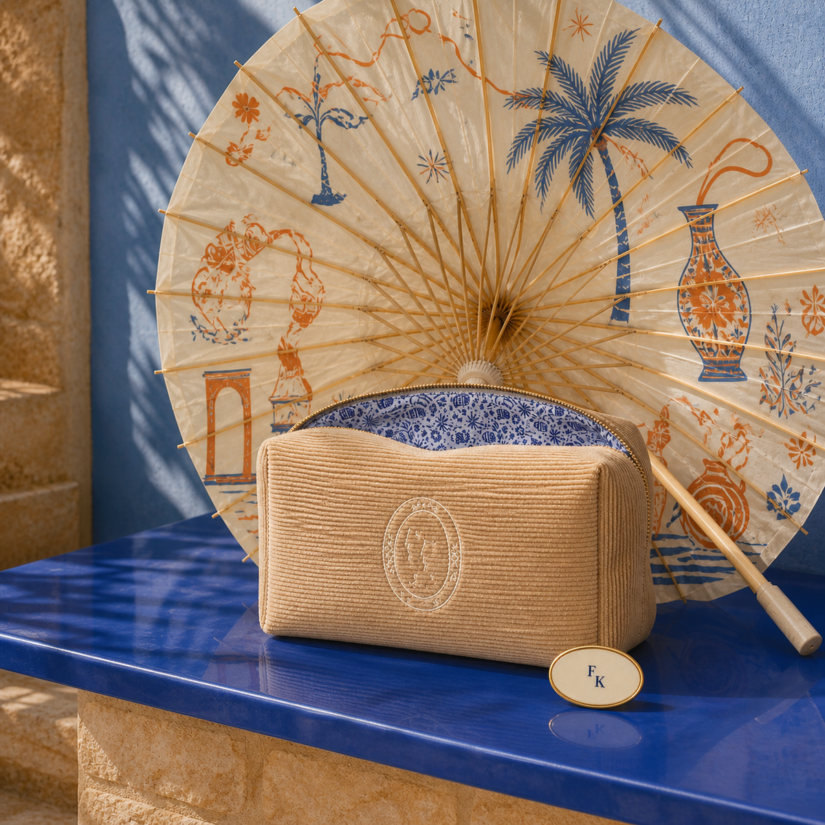 The Details Drop with custom parasol, bathroom bag, and oval pin
